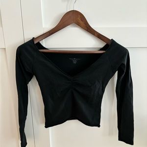 Brandy Melville long sleeve Black shoulder skimming crop top. NWT